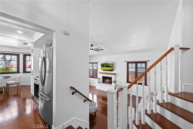 15 Vittoria St, Laguna Niguel, CA 92677 - staircase with wood finished floors, a brick fireplace, ceiling fan, baseboards, and ornamental molding