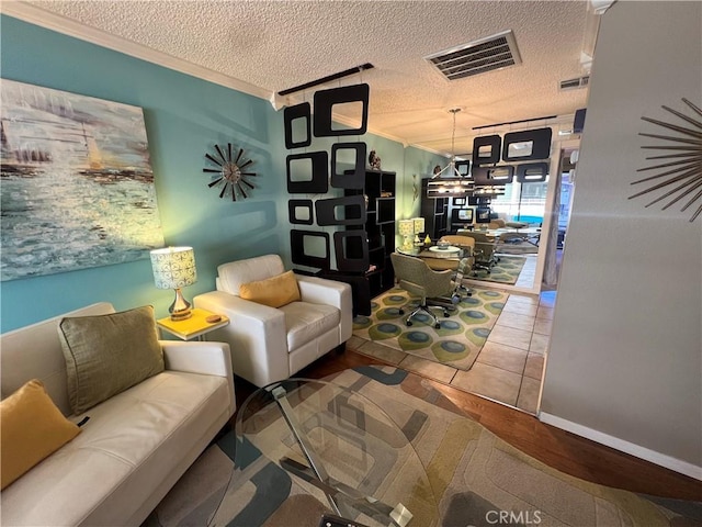 470 S Calle Encilia Unit B11, Palm Springs, CA 92262 - living room with ornamental molding, a textured ceiling, and a chandelier