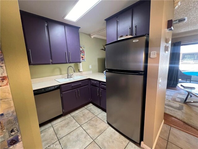 470 S Calle Encilia Unit B11, Palm Springs, CA 92262 - kitchen with stainless steel appliances, a sink, light tile patterned flooring, and light countertops