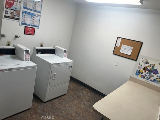 470 S Calle Encilia Unit B11, Palm Springs, CA 92262 - community laundry featuring washing machine and dryer, baseboards, and dark stone finish flooring