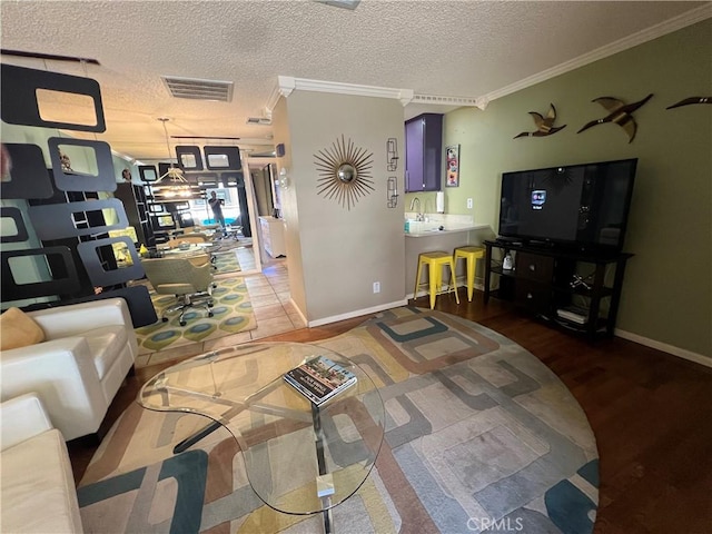 470 S Calle Encilia Unit B11, Palm Springs, CA 92262 - living area with crown molding, a textured ceiling, baseboards, and wood finished floors
