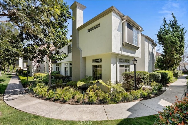 23622 Wakefield Ct Unit 69, Laguna Niguel, CA 92677 - view of side of property with a chimney and stucco siding