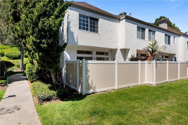 23622 Wakefield Ct Unit 69, Laguna Niguel, CA 92677 - view of front of home with stucco siding and a chimney