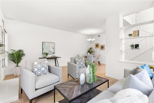 23622 Wakefield Ct Unit 69, Laguna Niguel, CA 92677 - living room with a chandelier, light wood-style floors, stairs, and baseboards
