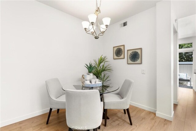 23622 Wakefield Ct Unit 69, Laguna Niguel, CA 92677 - dining area featuring a chandelier, light wood finished floors, and baseboards