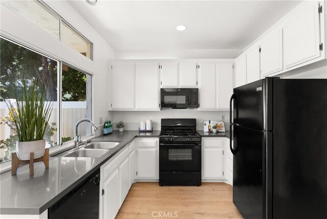 23622 Wakefield Ct Unit 69, Laguna Niguel, CA 92677 - kitchen with black appliances, a sink, light wood finished floors, white cabinetry, and recessed lighting