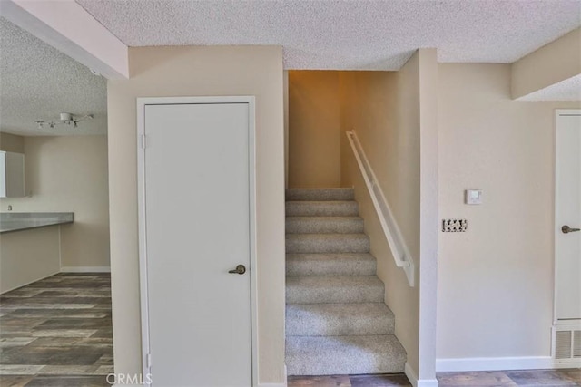 845 Daffodil Dr, Riverside, CA 92507 - stairs featuring a textured ceiling, wood finished floors, and baseboards