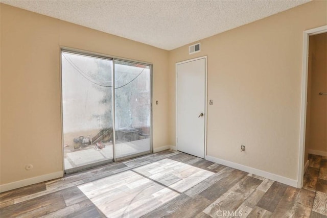 845 Daffodil Dr, Riverside, CA 92507 - spare room featuring wood finished floors, a textured ceiling, and baseboards