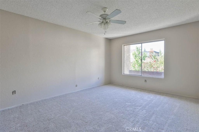 unfurnished room featuring carpet flooring, a textured ceiling, ceiling fan, and baseboards