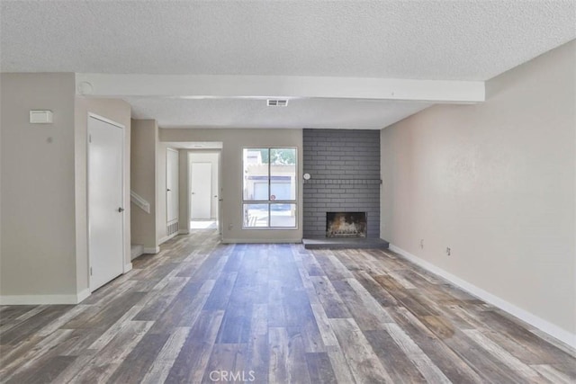 845 Daffodil Dr, Riverside, CA 92507 - unfurnished living room with a textured ceiling, wood finished floors, a fireplace, and baseboards