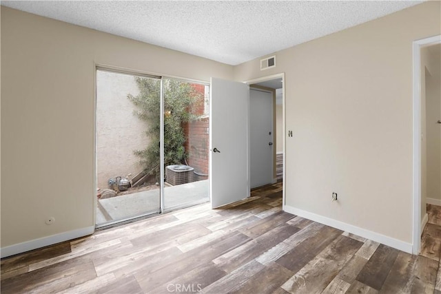 845 Daffodil Dr, Riverside, CA 92507 - spare room with wood finished floors, a textured ceiling, and baseboards