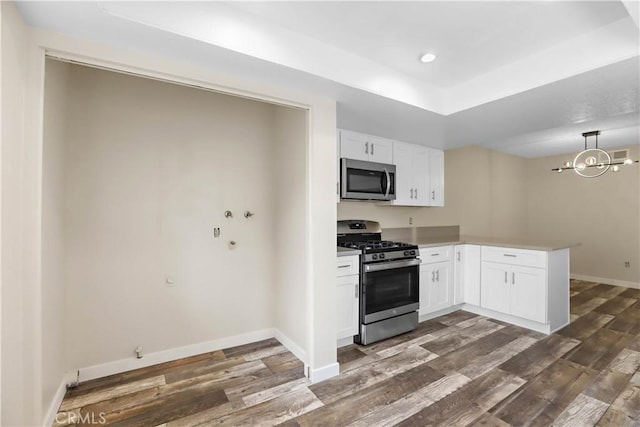 845 Daffodil Dr, Riverside, CA 92507 - kitchen featuring stainless steel appliances, a peninsula, white cabinetry, dark wood finished floors, and recessed lighting