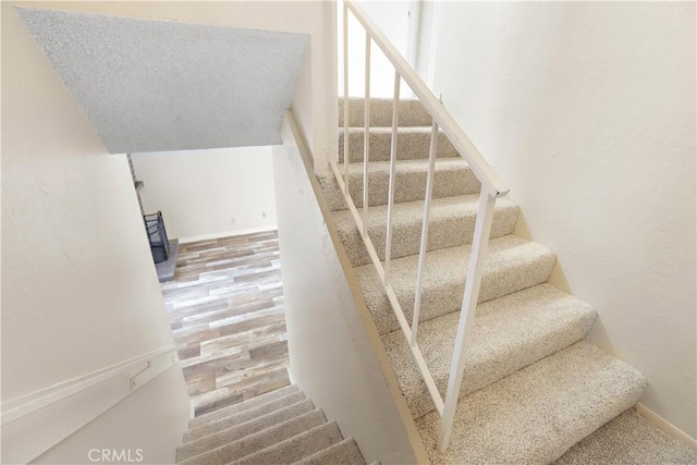 845 Daffodil Dr, Riverside, CA 92507 - stairs featuring a wood stove and baseboards