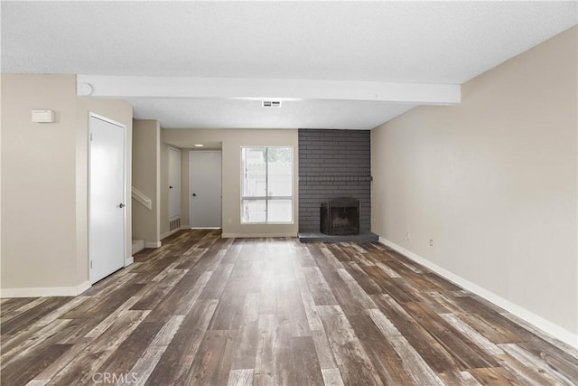 845 Daffodil Dr, Riverside, CA 92507 - unfurnished living room with wood finished floors, beamed ceiling, a fireplace, and baseboards