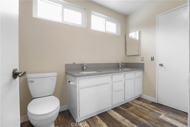 845 Daffodil Dr, Riverside, CA 92507 - bathroom with toilet, wood finished floors, double vanity, and baseboards