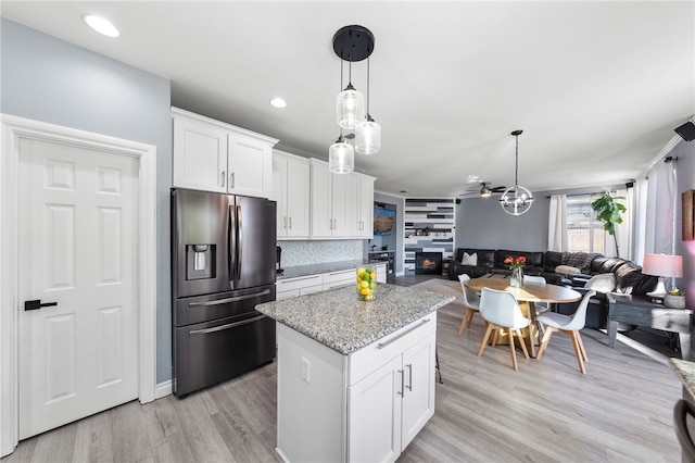 32871 Levi Ct, Temecula, CA 92592 - kitchen featuring stainless steel fridge, open floor plan, a kitchen island, white cabinetry, and pendant lighting