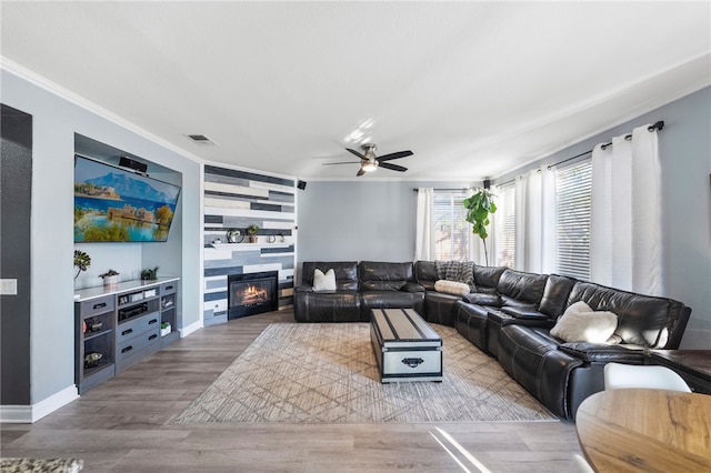 32871 Levi Ct, Temecula, CA 92592 - living area featuring ornamental molding, ceiling fan, wood finished floors, and a large fireplace