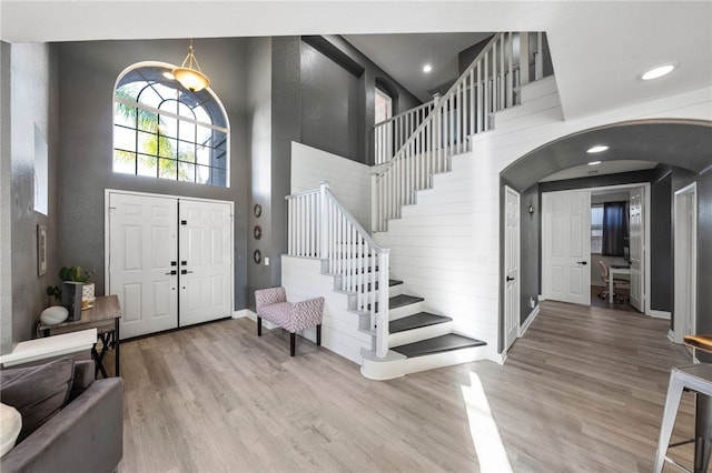 32871 Levi Ct, Temecula, CA 92592 - entrance foyer featuring wood finished floors, arched walkways, a towering ceiling, stairs, and recessed lighting