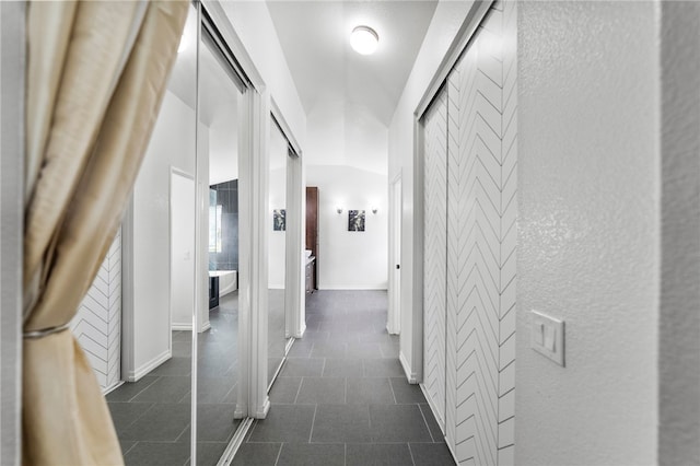32871 Levi Ct, Temecula, CA 92592 - corridor with dark tile patterned floors and a textured wall
