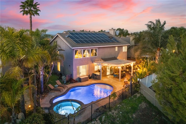 32871 Levi Ct, Temecula, CA 92592 - back of house with solar panels, stucco siding, a fenced backyard, a chimney, and a patio area