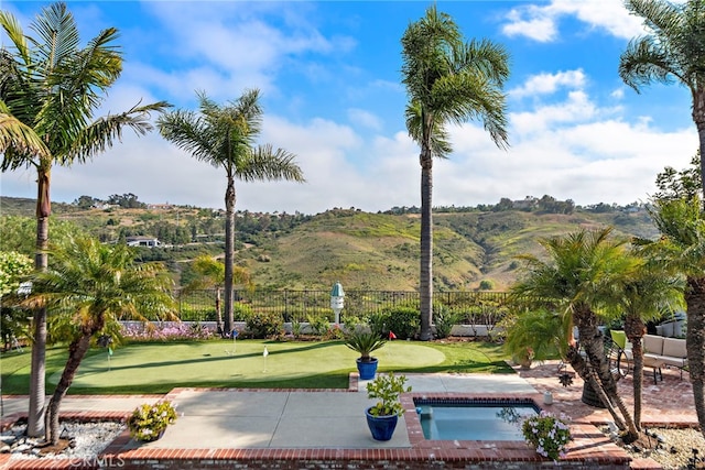 8 Capri, Laguna Niguel, CA 92677 - surrounding community with an area to practice putting, a mountain view, and a patio
