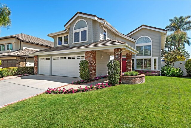 8 Capri, Laguna Niguel, CA 92677 - traditional-style house with driveway, a front lawn, an attached garage, and brick siding