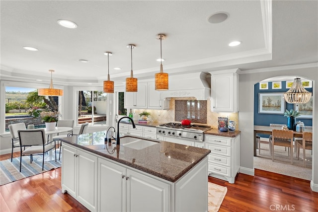 8 Capri, Laguna Niguel, CA 92677 - kitchen with white cabinets, tasteful backsplash, dark wood finished floors, a sink, and ornamental molding