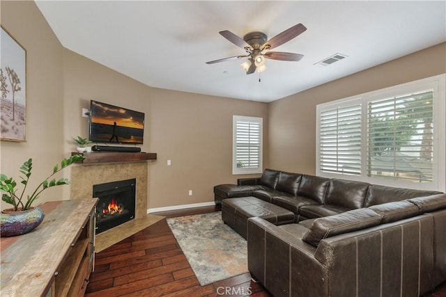 1709 Duncan Way, Corona, CA 92881 - living area with a ceiling fan, dark wood-style flooring, a fireplace with flush hearth, and baseboards