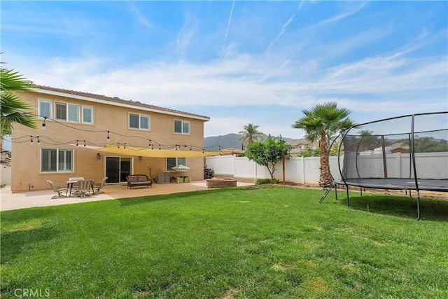 1709 Duncan Way, Corona, CA 92881 - back of house with stucco siding, a trampoline, and a patio area