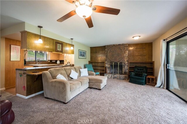 3876 Orcutt Rd, San Luis Obispo, CA 93401 - living room featuring plenty of natural light, carpet flooring, a fireplace, ceiling fan, and wood walls