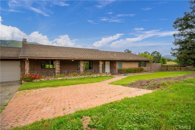 3876 Orcutt Rd, San Luis Obispo, CA 93401 - ranch-style home with stone siding, a chimney, an attached garage, and driveway