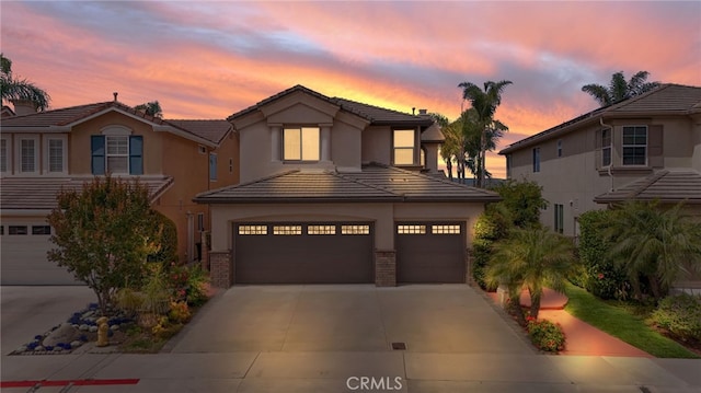 27781 Country Lane Rd, Laguna Niguel, CA 92677 - view of front facade with a garage, concrete driveway, a tiled roof, and stucco siding