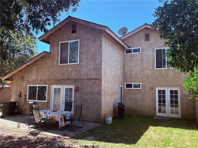 22523 Enadia Way, West Hills, CA 91307 - back of house featuring french doors, stucco siding, a patio, a lawn, and central AC