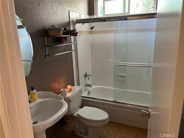 22523 Enadia Way, West Hills, CA 91307 - bathroom with toilet, a sink, tile patterned flooring, and bath / shower combo with glass door
