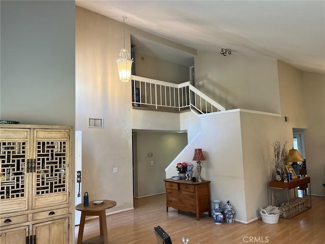 22523 Enadia Way, West Hills, CA 91307 - staircase featuring a towering ceiling, wood finished floors, and baseboards