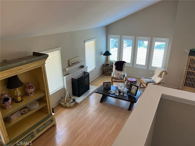 22523 Enadia Way, West Hills, CA 91307 - living area featuring lofted ceiling, light wood finished floors, and a brick fireplace