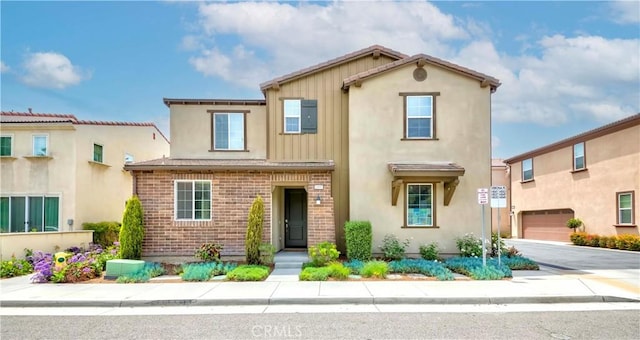 14533 Verona Pl, Eastvale, CA 92880 - view of front of house with brick siding, a garage, driveway, and board and batten siding