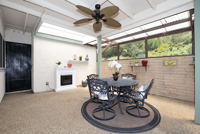 4402 Shearwater Way, Oceanside, CA 92057 - view of patio / terrace featuring a fireplace with raised hearth, ceiling fan, and outdoor dining space