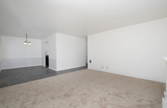 4402 Shearwater Way, Oceanside, CA 92057 - unfurnished room featuring a chandelier, dark carpet, dark tile patterned flooring, and baseboards