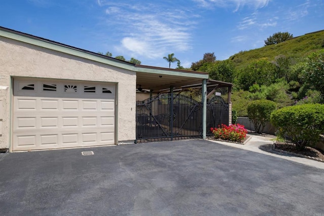 4402 Shearwater Way, Oceanside, CA 92057 - garage featuring driveway and a gate