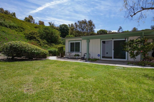 4402 Shearwater Way, Oceanside, CA 92057 - rear view of house featuring a yard and board and batten siding