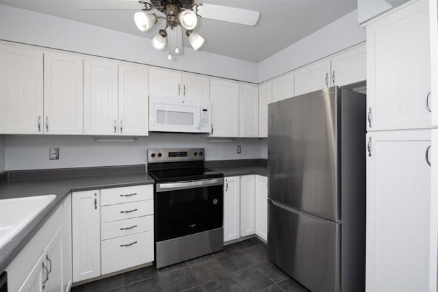 4402 Shearwater Way, Oceanside, CA 92057 - kitchen with stainless steel appliances, a ceiling fan, white cabinetry, dark countertops, and a sink