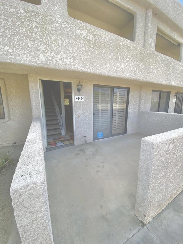 34354 Laura Way, Rancho Mirage, CA 92270 - view of exterior entry featuring stucco siding and a patio area