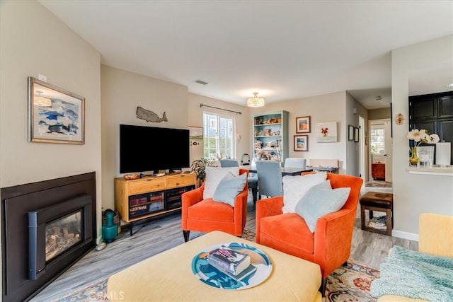 150 Cypress Ave Unit 28, Cayucos, CA 93430 - living area featuring light wood finished floors, baseboards, and a glass covered fireplace