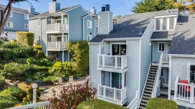150 Cypress Ave Unit 28, Cayucos, CA 93430 - rear view of house featuring a chimney and a shingled roof