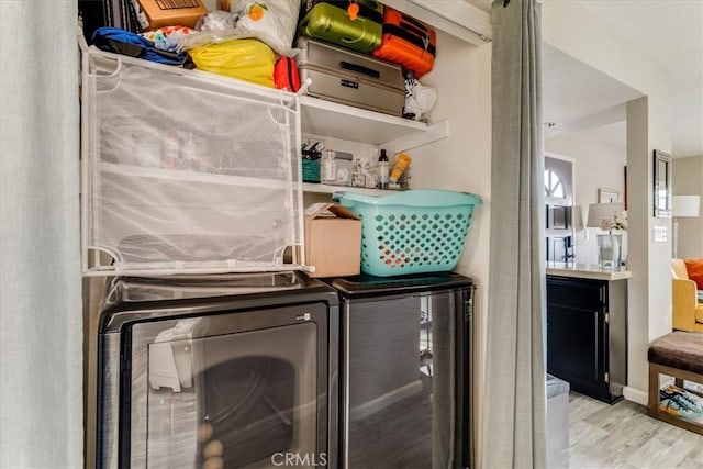 150 Cypress Ave Unit 28, Cayucos, CA 93430 - laundry area with washer and clothes dryer and wood finished floors