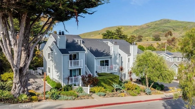 150 Cypress Ave Unit 28, Cayucos, CA 93430 - view of front of house with a chimney and a mountain view