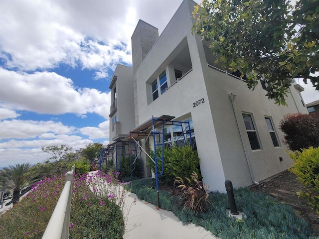 2072 Tango Loop Unit 2, Chula Vista, CA 91915 - view of side of property with stucco siding and a chimney