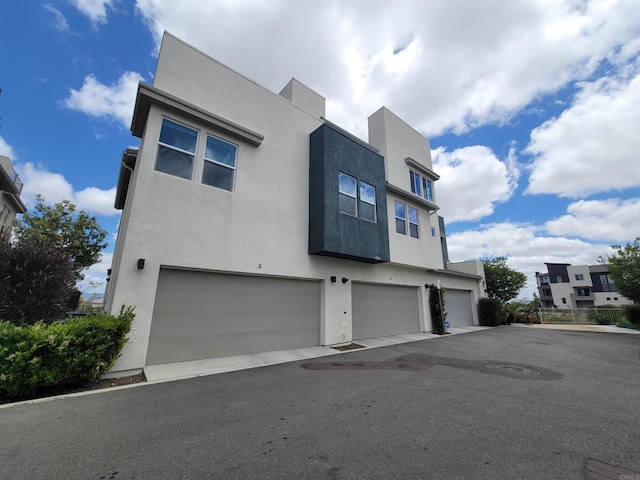 2072 Tango Loop Unit 2, Chula Vista, CA 91915 - view of front of property with stucco siding and a garage