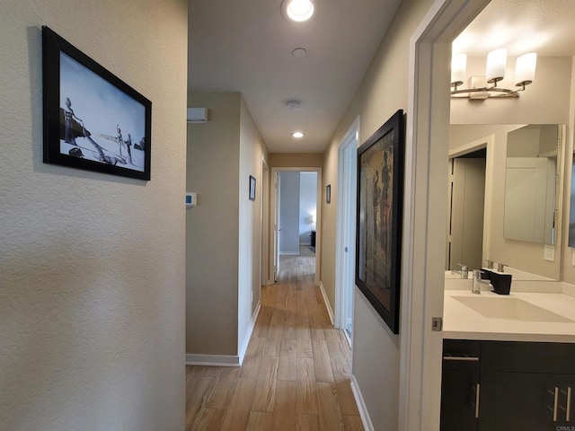 2072 Tango Loop Unit 2, Chula Vista, CA 91915 - hall with light wood finished floors, baseboards, recessed lighting, and a sink